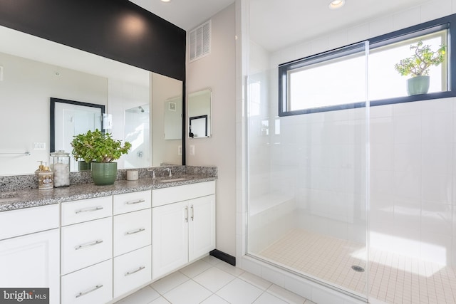 bathroom featuring a stall shower, visible vents, a sink, and double vanity