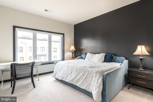 bedroom with light carpet and visible vents