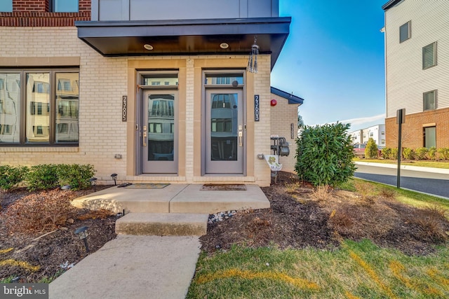 property entrance featuring brick siding