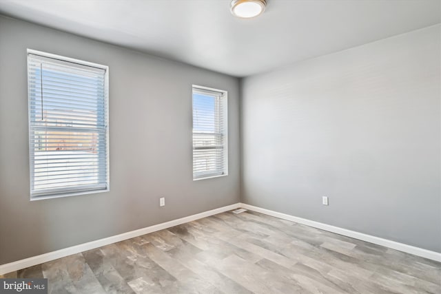 spare room with light hardwood / wood-style flooring