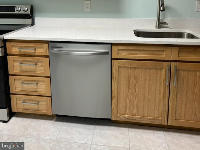 kitchen with stainless steel appliances, sink, and light tile patterned floors