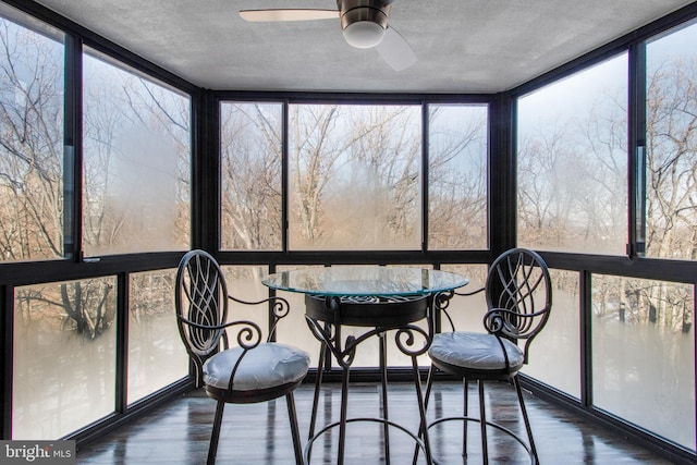 unfurnished sunroom with a wealth of natural light and ceiling fan