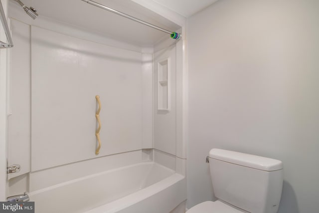 bathroom featuring shower / bathtub combination and toilet