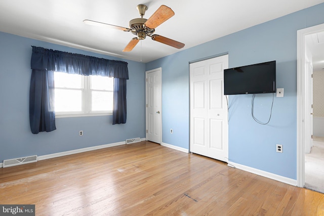 unfurnished bedroom with hardwood / wood-style floors and ceiling fan