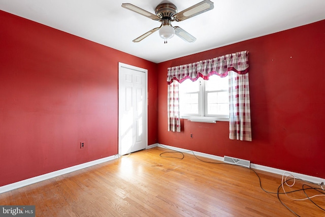 empty room featuring hardwood / wood-style flooring and ceiling fan