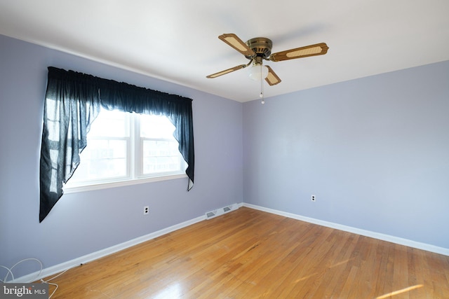 unfurnished room with hardwood / wood-style flooring and ceiling fan