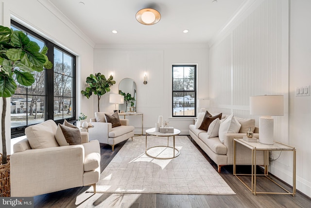 living room with ornamental molding, a wealth of natural light, and dark hardwood / wood-style flooring