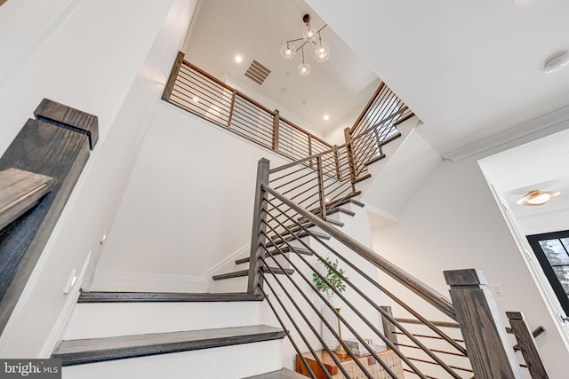 staircase with a towering ceiling