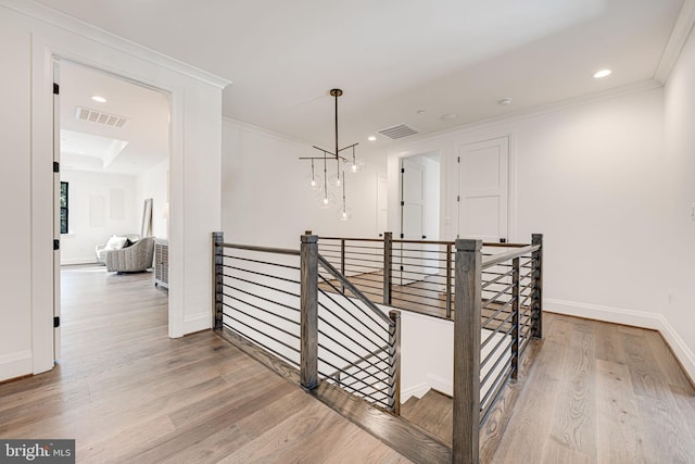 hall featuring crown molding and hardwood / wood-style flooring