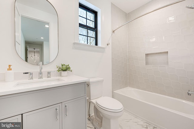 full bathroom featuring tiled shower / bath combo, vanity, and toilet