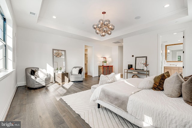 bedroom featuring an inviting chandelier, dark hardwood / wood-style floors, and a raised ceiling