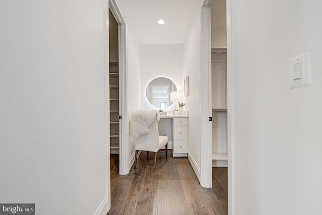 corridor with hardwood / wood-style flooring