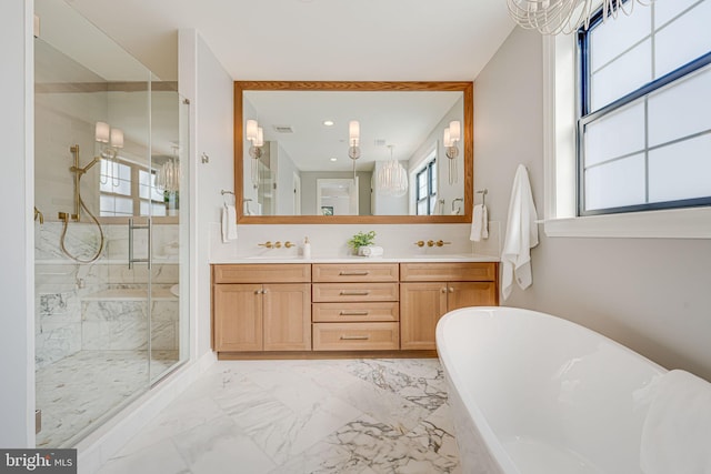 bathroom with independent shower and bath, vanity, and a healthy amount of sunlight