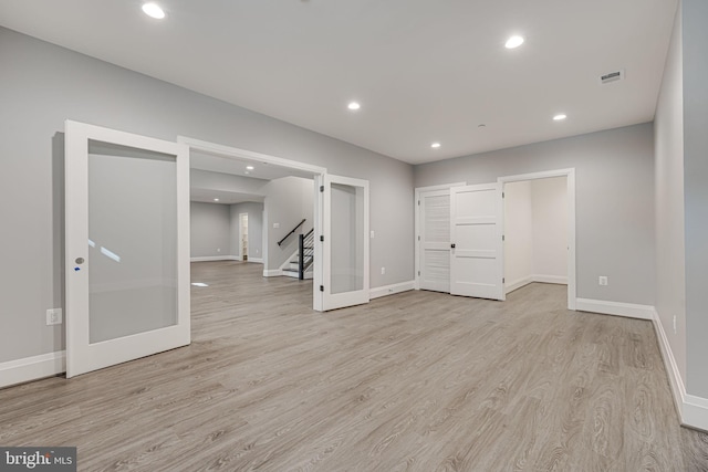 interior space featuring light wood-type flooring and french doors