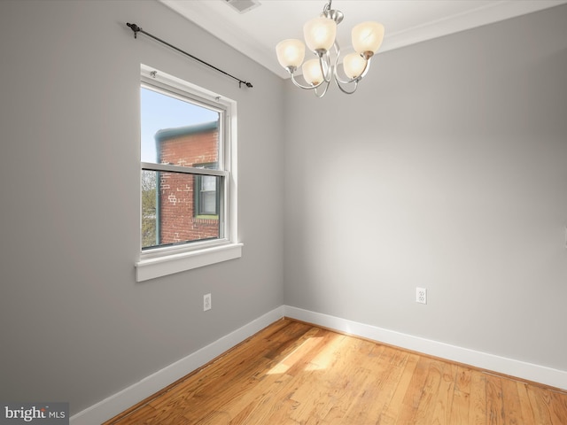 2615 4th St NE Unit 303, Washington, DC 20002 - spare room featuring baseboards, a chandelier, and light wood-style flooring