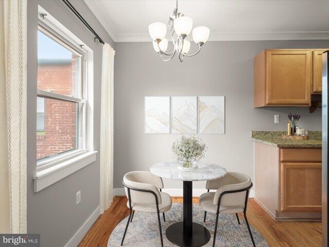 2615 4th St NE Unit 303, Washington, DC 20002 - dining space with a chandelier, crown molding, light wood-style floors, and baseboards