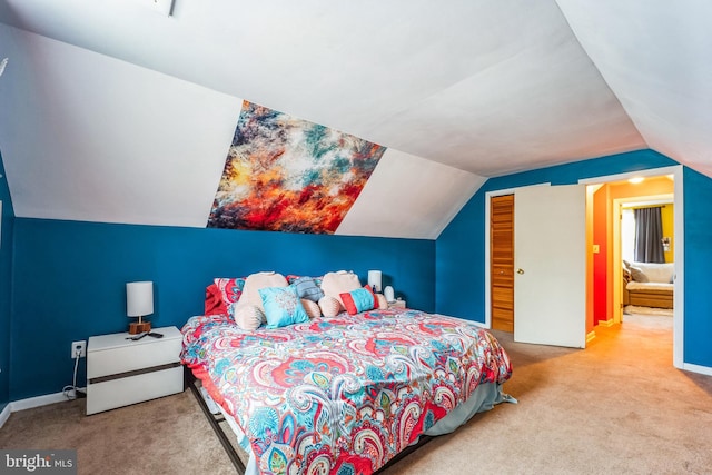 bedroom with lofted ceiling, a closet, and carpet flooring