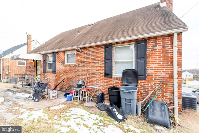 back of house with central air condition unit