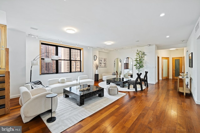 living room featuring rail lighting and hardwood / wood-style floors