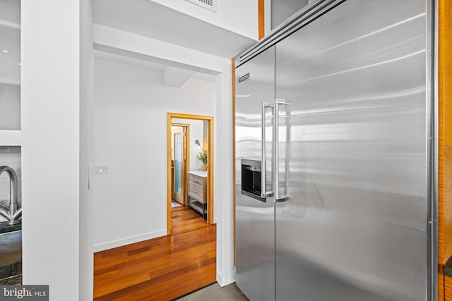 kitchen with light hardwood / wood-style floors and stainless steel built in fridge