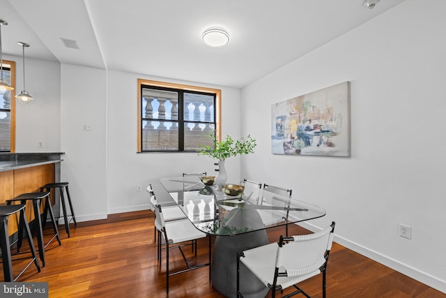 dining space featuring dark hardwood / wood-style floors