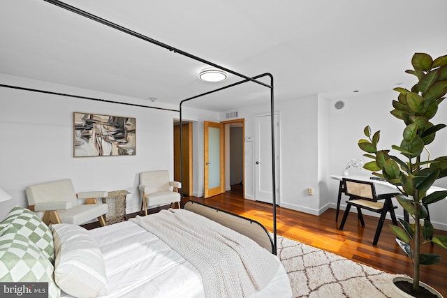 bedroom featuring wood-type flooring