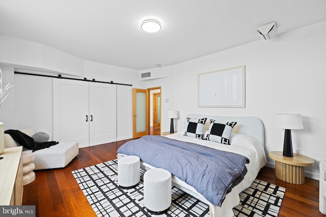 bedroom with dark hardwood / wood-style flooring