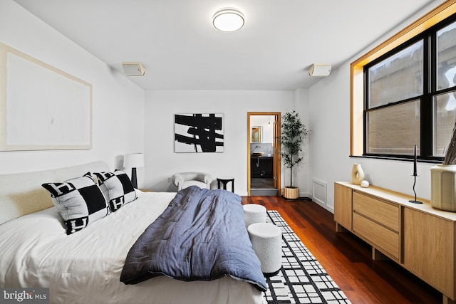 bedroom with dark hardwood / wood-style floors