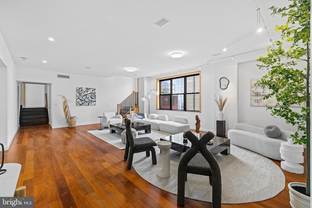 living room with hardwood / wood-style floors and rail lighting