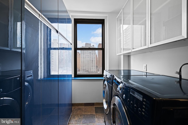 washroom featuring cabinets and independent washer and dryer