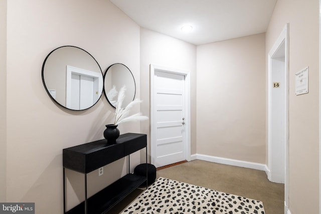 foyer entrance with light carpet