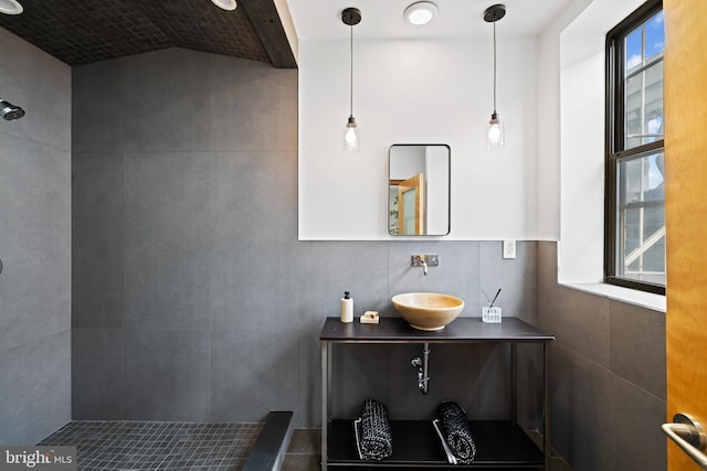 bathroom with vanity and a tile shower