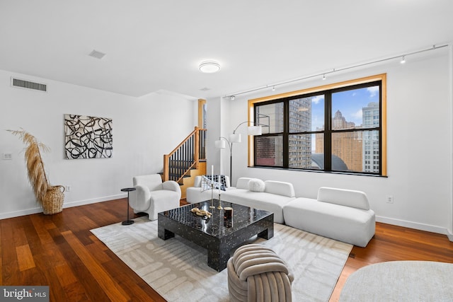 living room with hardwood / wood-style flooring and track lighting