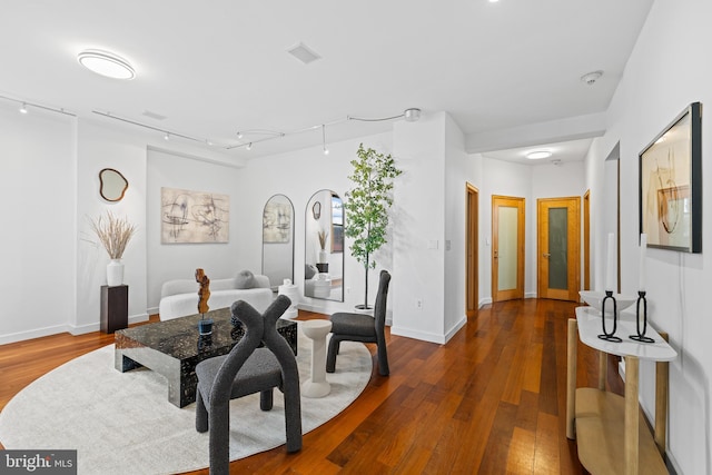 interior space with hardwood / wood-style flooring and rail lighting