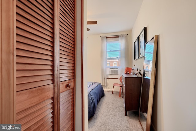 bedroom with cooling unit and light colored carpet