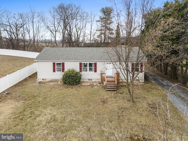 rear view of property featuring a lawn