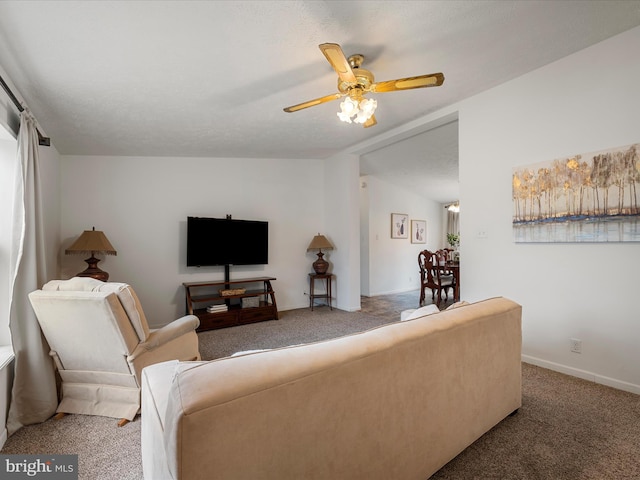 living room featuring carpet floors, ceiling fan, and vaulted ceiling