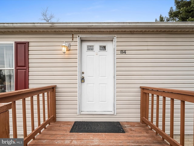 view of exterior entry with a deck