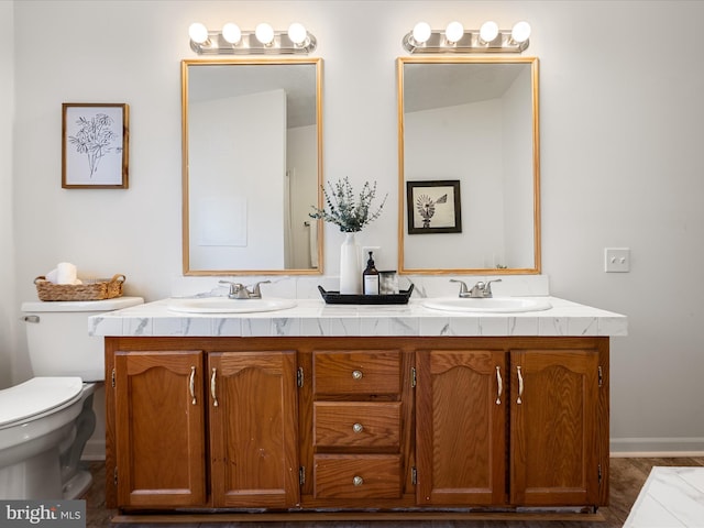 bathroom featuring vanity and toilet