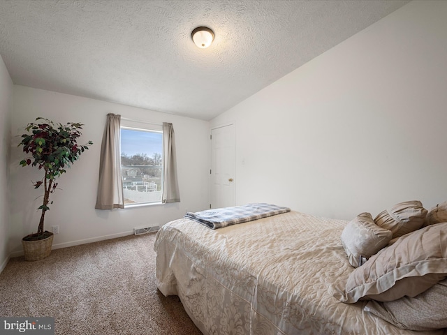 carpeted bedroom featuring vaulted ceiling and a textured ceiling