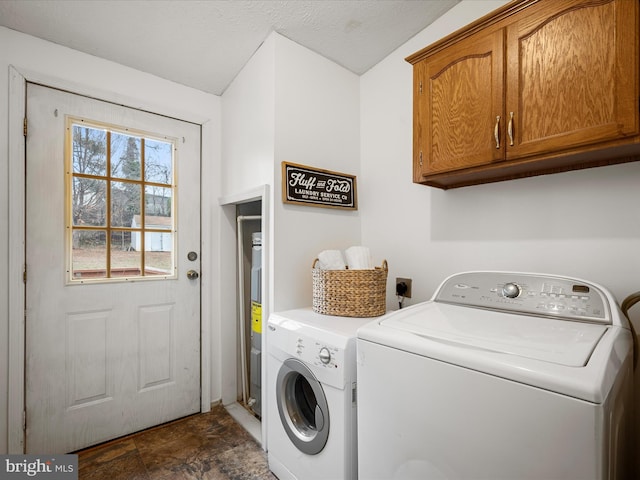 washroom featuring cabinets and independent washer and dryer