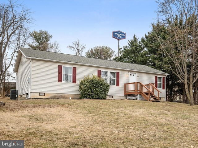 manufactured / mobile home with central AC unit and a front lawn