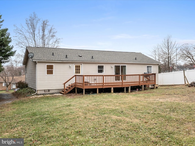 rear view of house with a yard and a deck