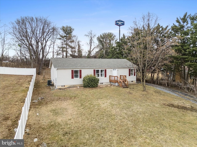 view of front of home with central AC and a front lawn