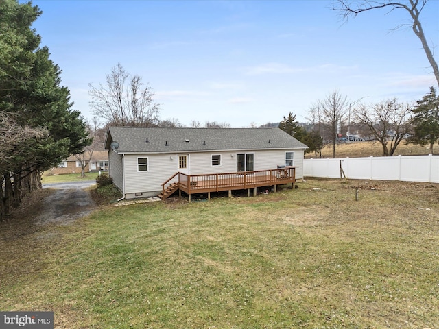 back of house featuring a yard and a deck