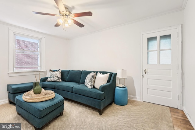 living room with hardwood / wood-style floors, ornamental molding, and ceiling fan