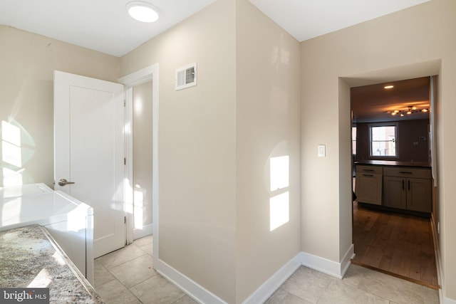 corridor with light tile patterned floors