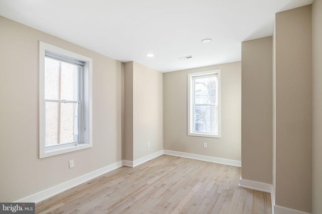 spare room featuring plenty of natural light and light wood-type flooring