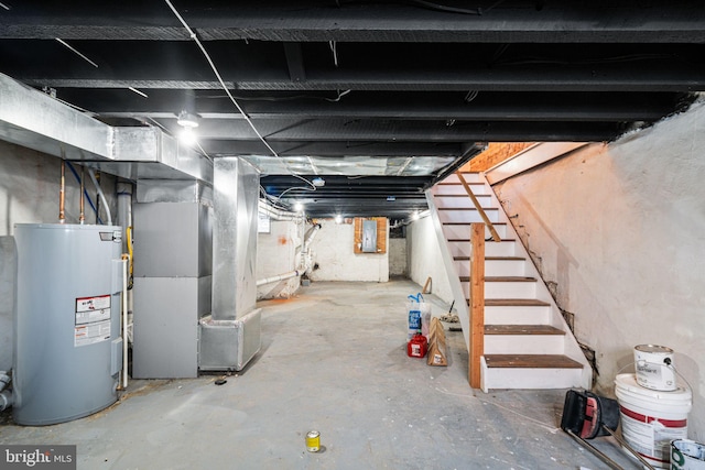 basement featuring electric panel, heating unit, and water heater