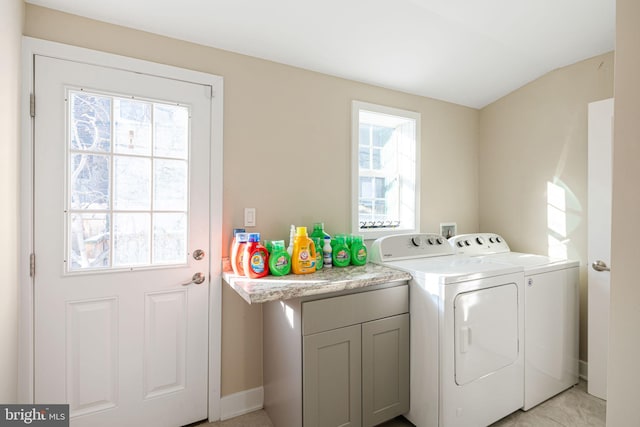 washroom featuring washing machine and dryer and cabinets